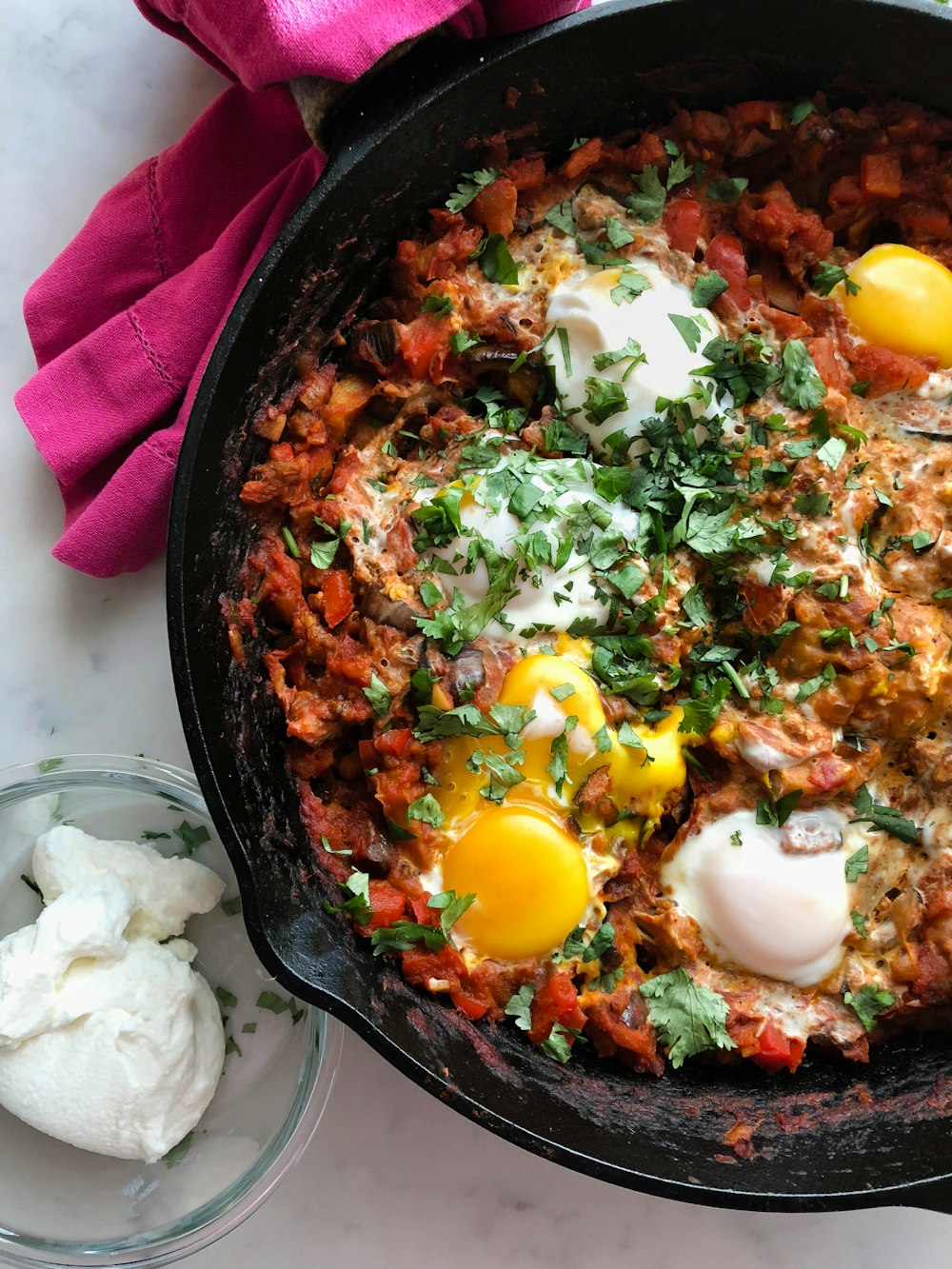 cooked meat with eggs in skillet