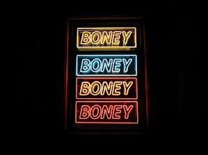 photo of yellow, blue, and red Boney neon sign