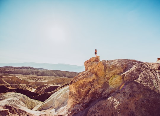 person standing on top of mountain in Death Valley United States