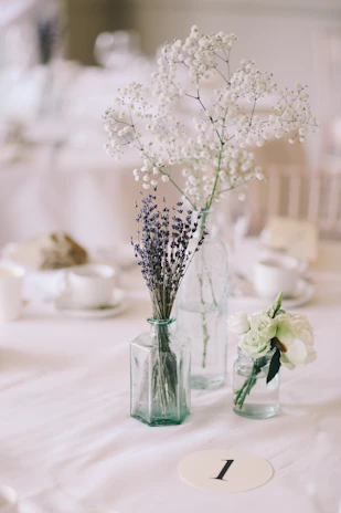 Close-up of a refined floral centerpiece in muted lavender and cream, reflecting a luxurious organic style.