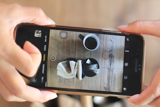 A user holding a smartphone taking a photo of a chair with a reference object next to it.