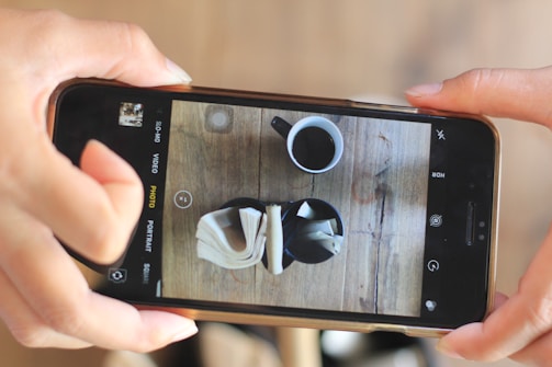 A user holding a smartphone taking a photo of a chair with a reference object next to it.