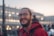 shallow focus photography of man wearing red hoodie