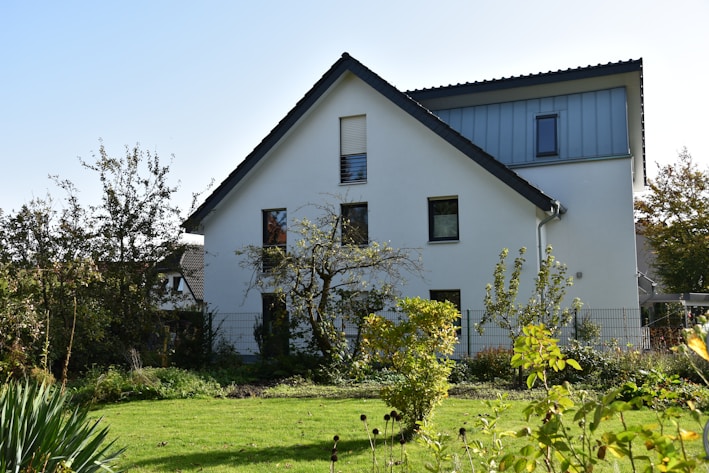 A cozy modern house with a well-kept garden in a sunny neighborhood