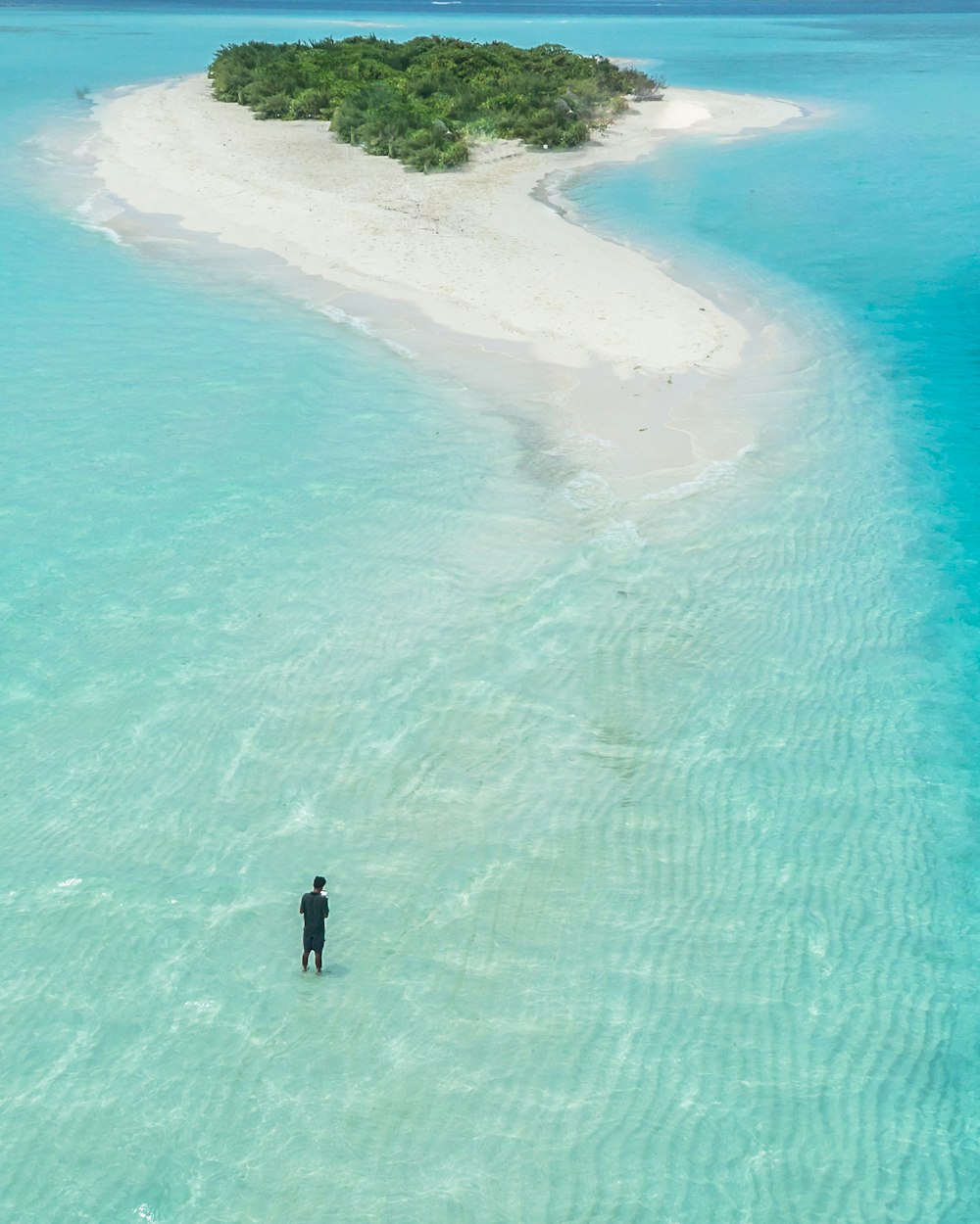 bird's eye view photography of man standing on body of water