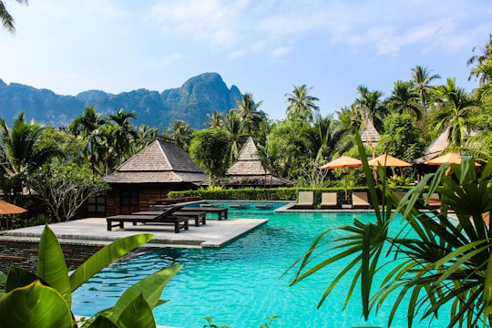 photo of brown bench near swimming pool in Ao Nang Thailand