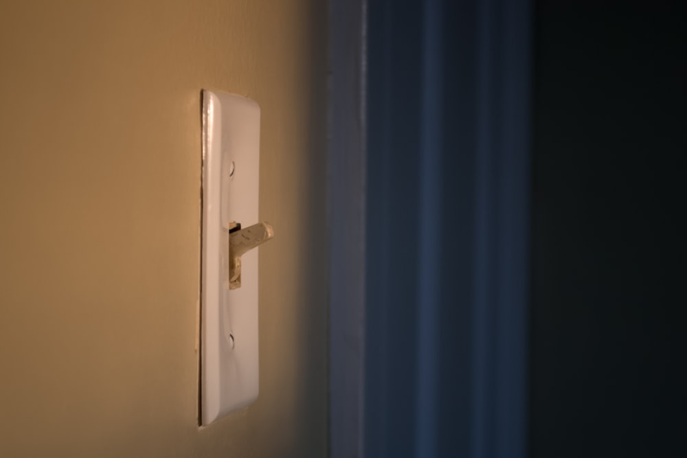 white switch mounted on blue wall