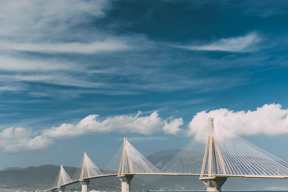 white cantilever bridge under blue sky