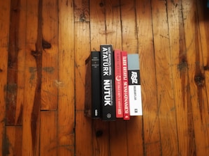 Stacks of finished books ready for distribution on a wooden table.