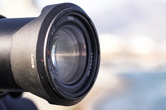 Karl Zeiss ophthalmoscope held in hand showing its design details against a blurred background