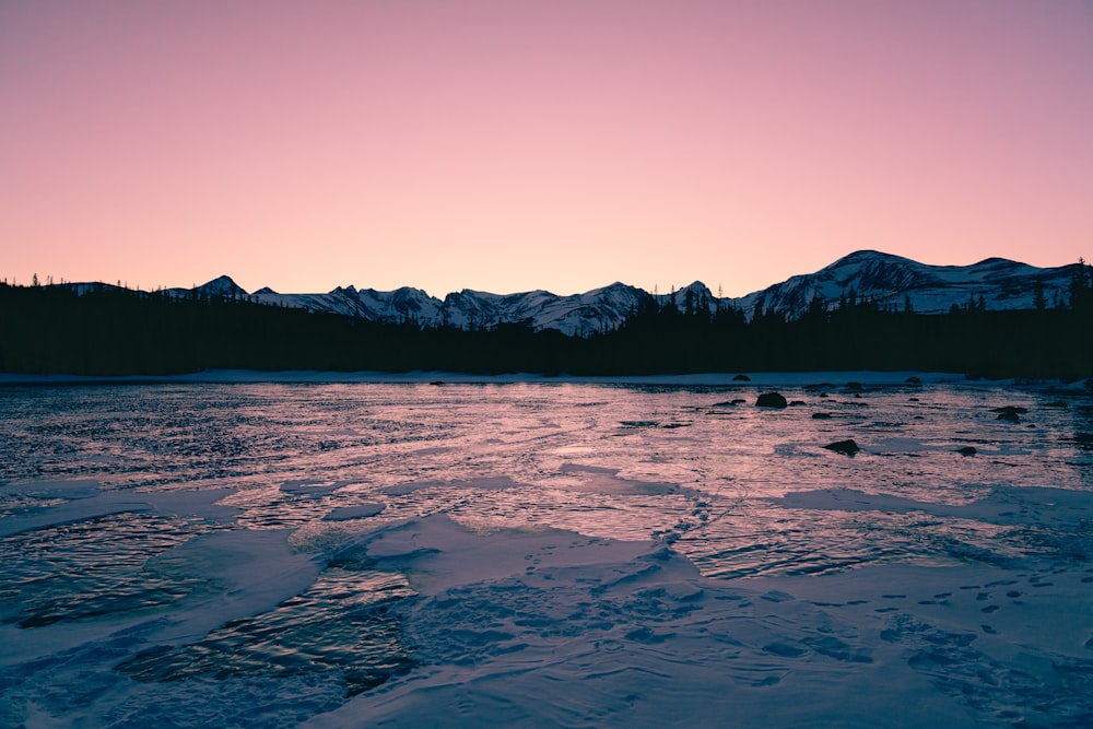 photo of lake in forest during sunrise