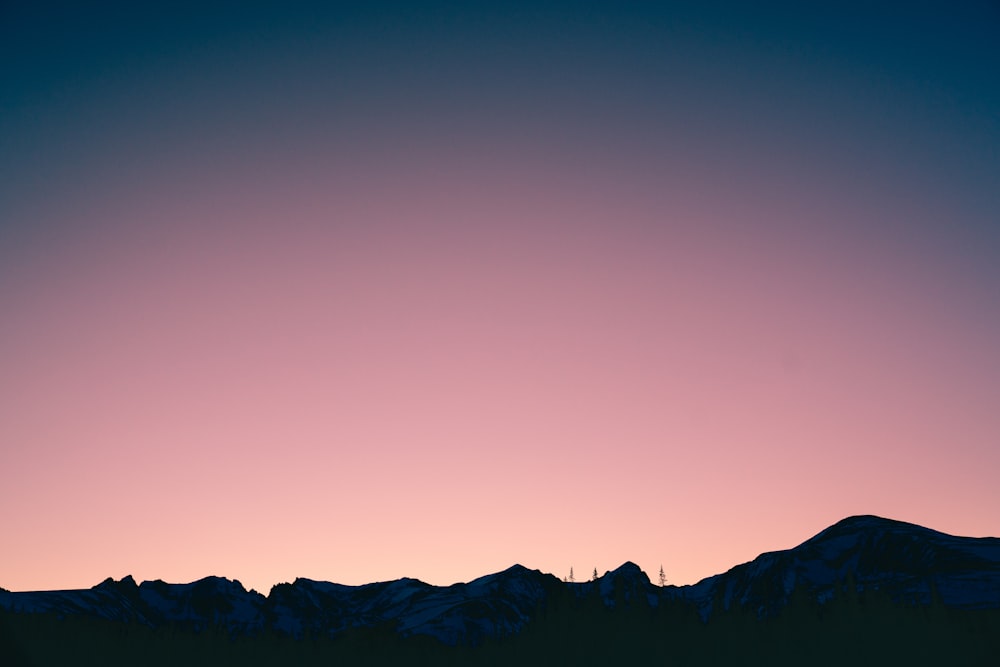 silhouette of mountain with pink sky