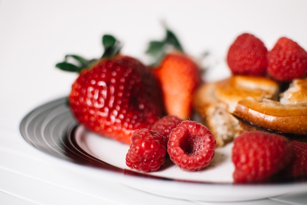 red strawberries on white and black plate