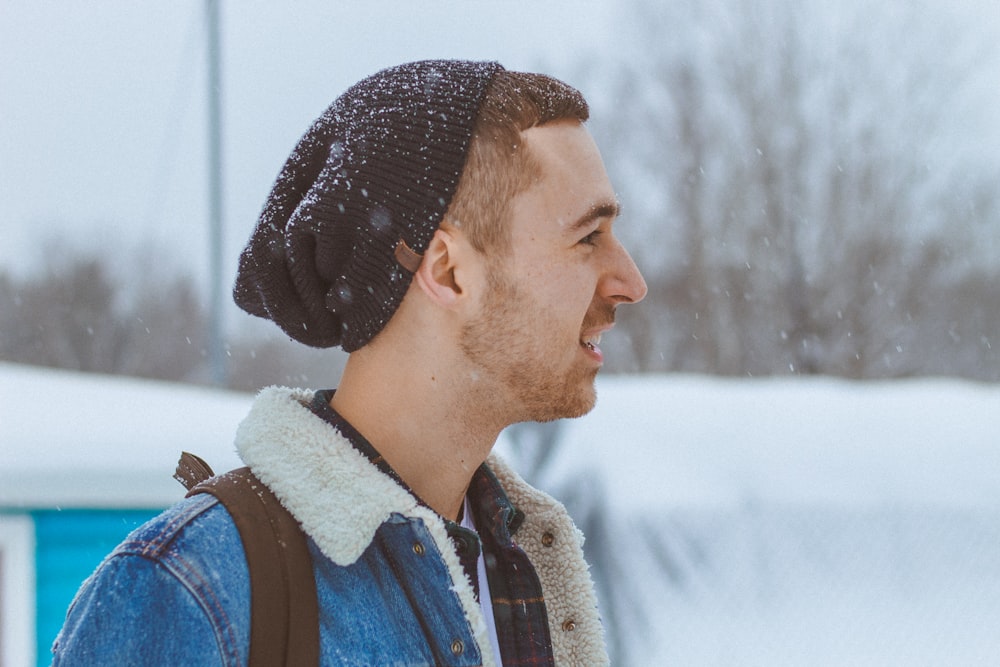 man carrying backpack during snow time