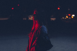 woman carrying bag during nighttime