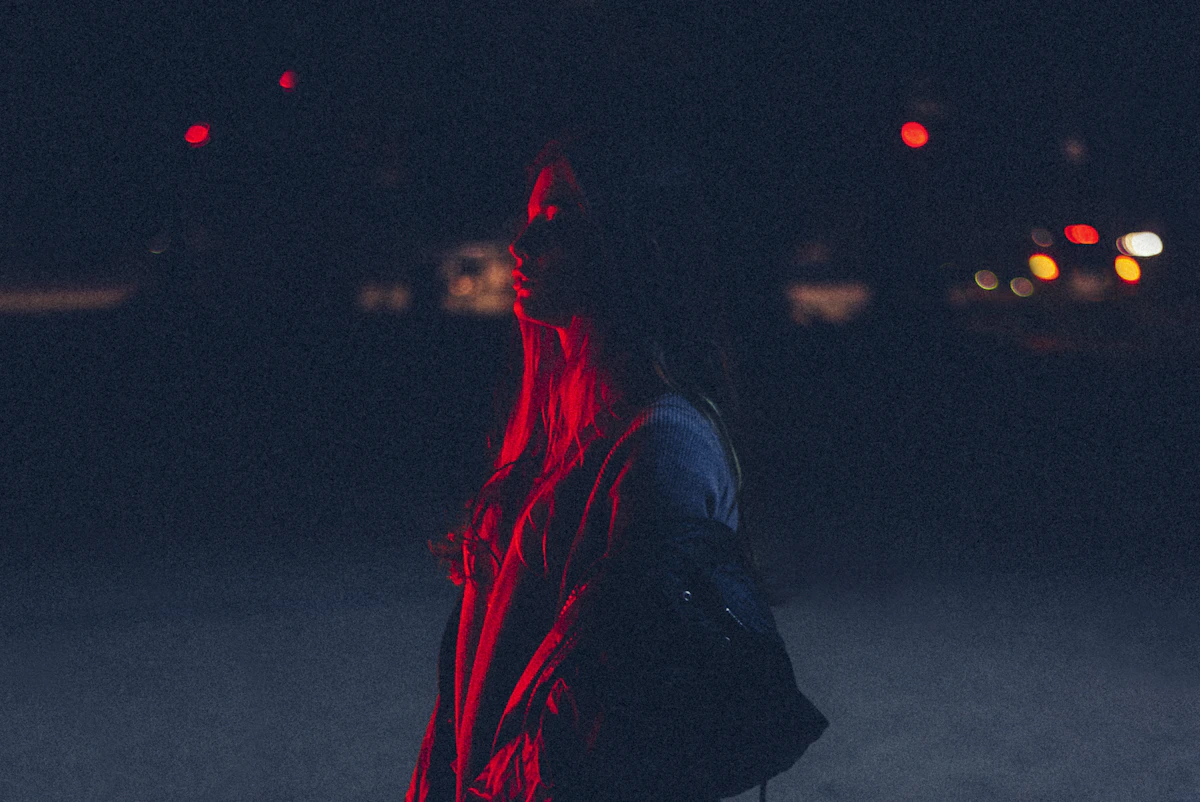 A woman carrying her evening home through the dark