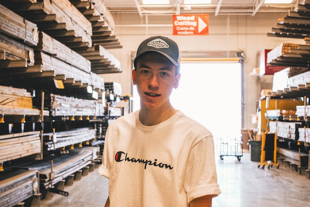 man wearing white Champion crew-neck tee shirt and gray fitted cap