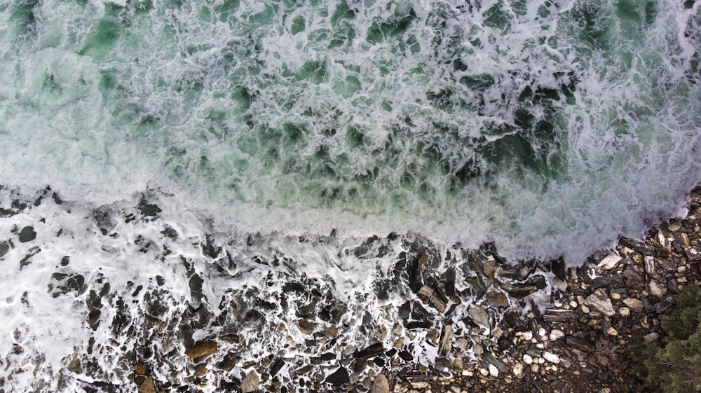 aerial photography of ocean waves near seashore during daytime