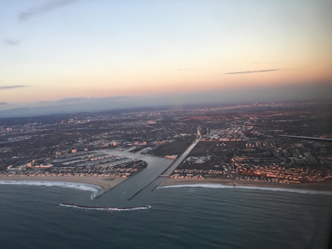 A vibrant photo of Alanya's coastline at sunset with digital map overlays