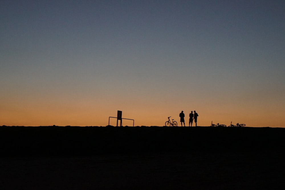 silhouette photography of three people