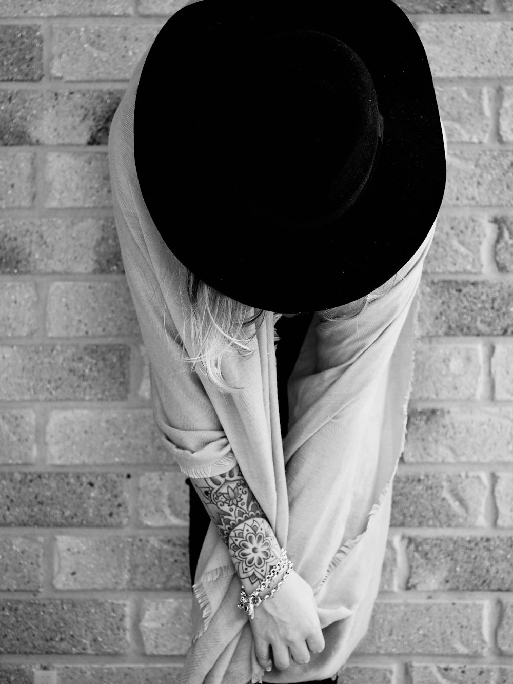 grayscale photo of woman sitting on surface