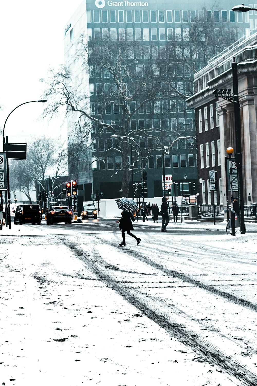 person running on road holding umbrella near vehicles at daytime