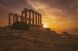 white concrete temple frame near body of water