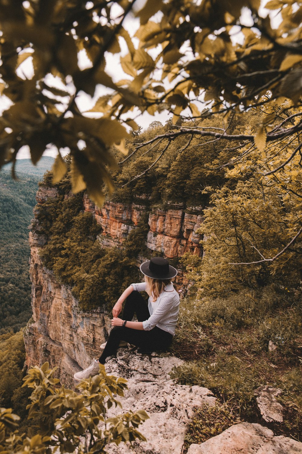山の崖に座っている女性