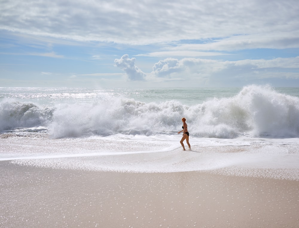 woman facing ocean waves