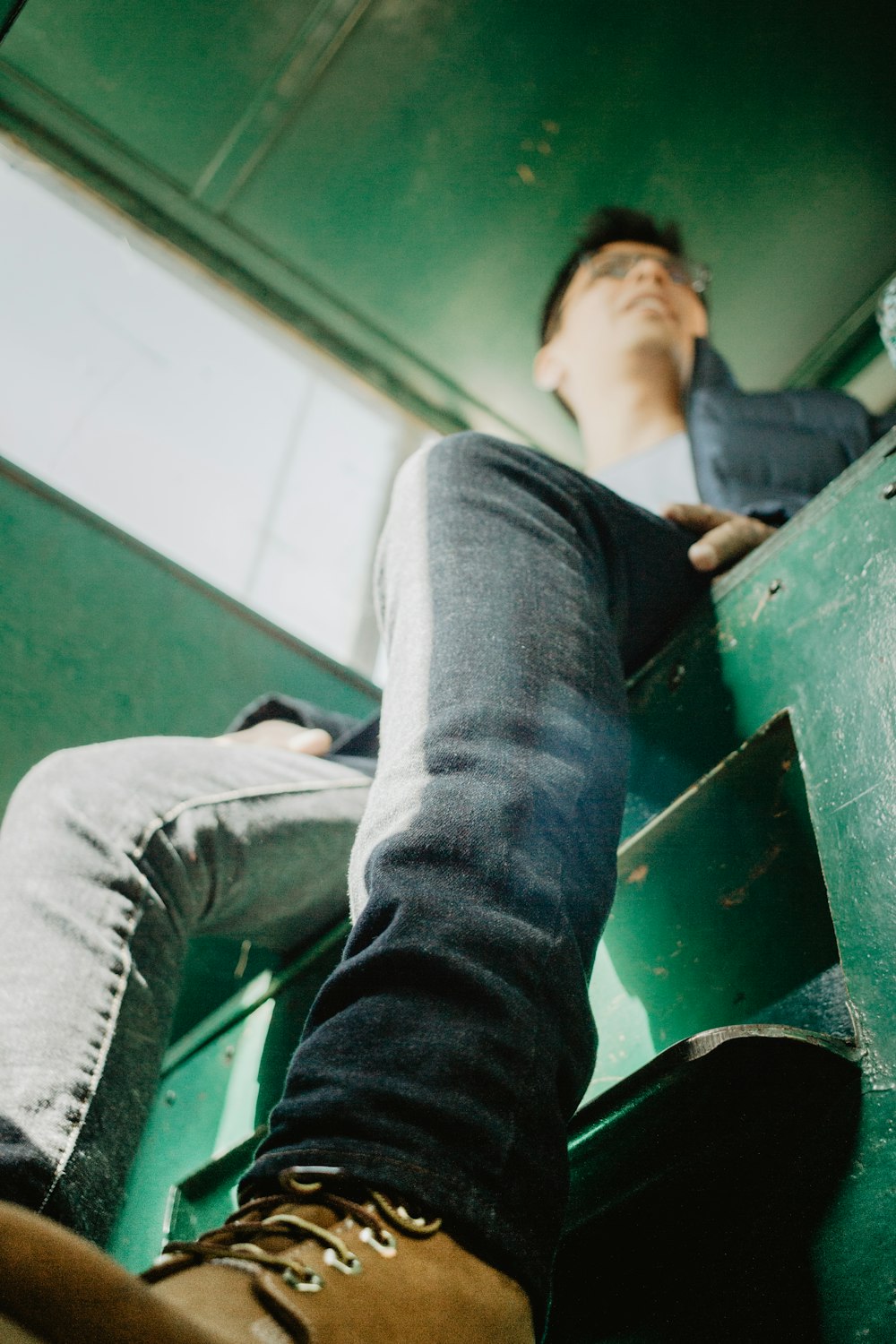 closeup photo of person sitting on green chair