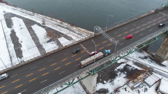 aerial photography of vehicles on steel bridge viewing blue body of water during daytime in Jacques-Cartier Bridge Canada