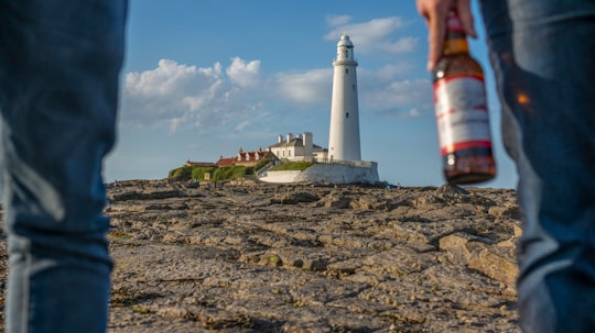 two person facing lighthouse in St. Mary's Lighthouse United Kingdom