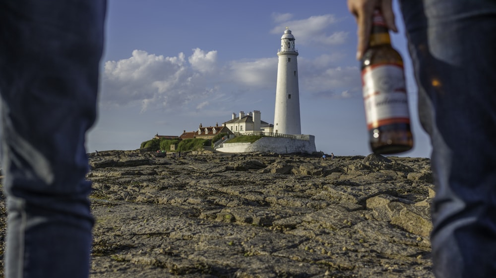 two person facing lighthouse