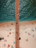 bird's-eye view photography of brown wooden dock on body of water