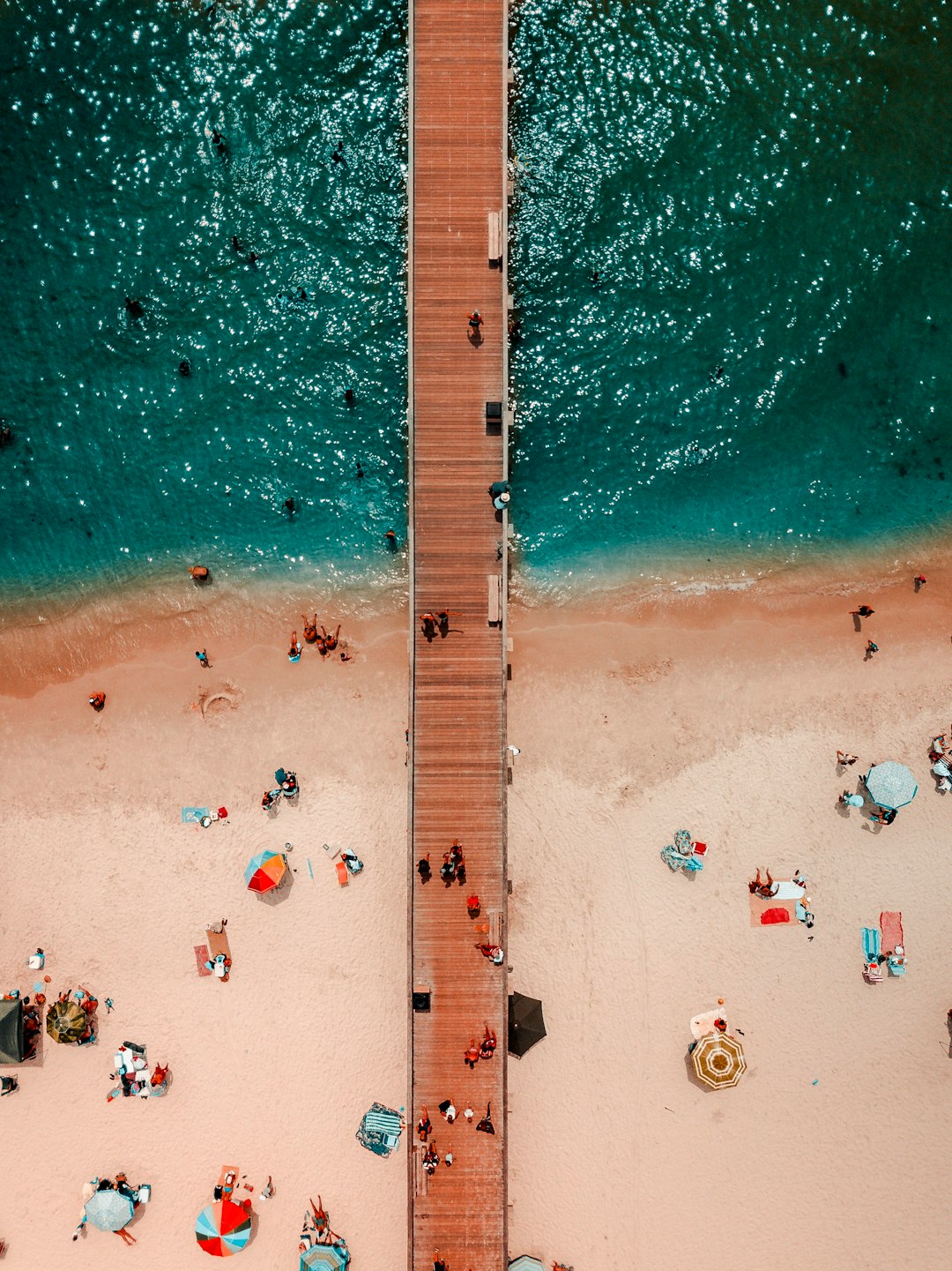 bird's-eye view photography of brown wooden dock on body of water