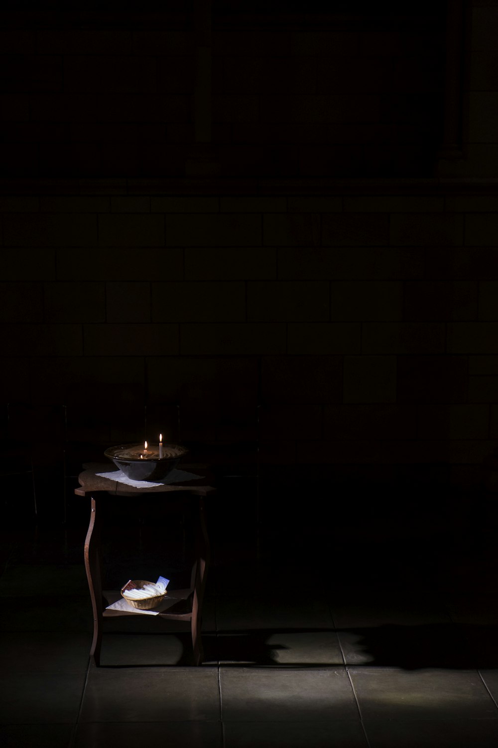 brown wooden table on dark area