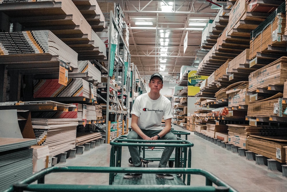 man sitting on gray trolley