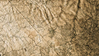 A vintage map of Southern Maryland with landmarks highlighted against a rustic wooden background.