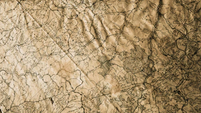 A vintage topographic map with burgundy ink annotations marking historical sites.