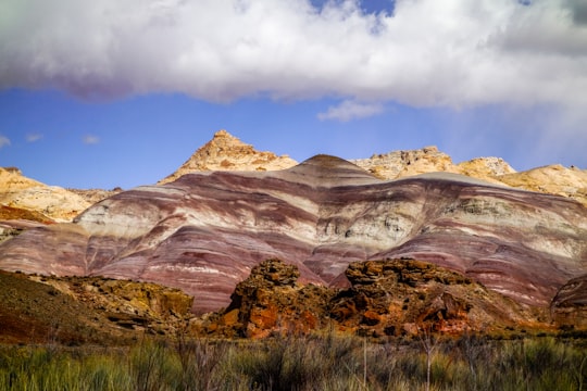 brown rocky mountain under blue sky during daytime in San Rafael Swell United States