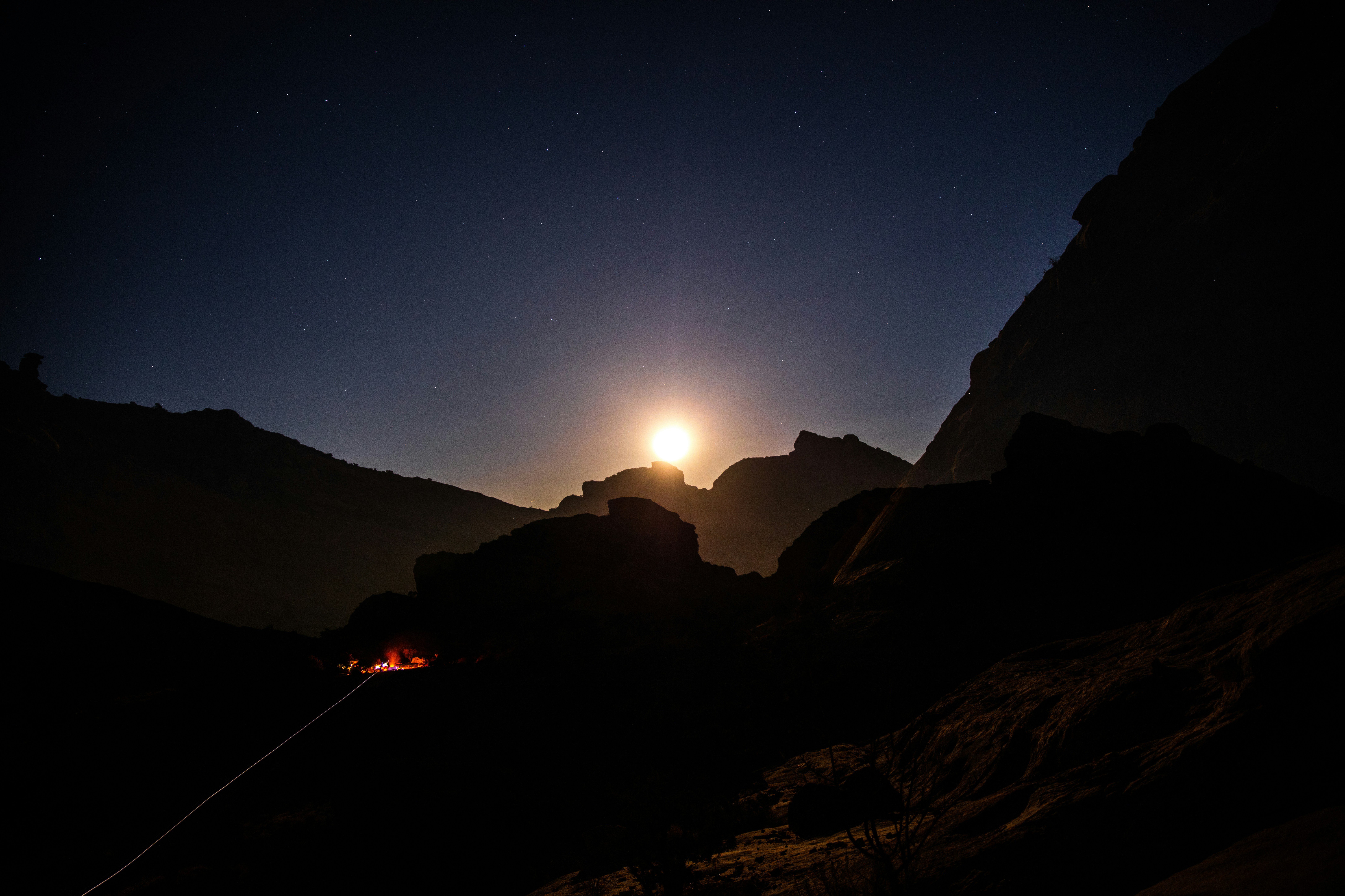 silhouette of mountain, I set up camp and along came other campers (lower left) who started a camp fire. I centered the rising moon and did a longer exposure. Once the camera was open, I then zoomed out on the moon, leaving this double exposure effect. This is one shot with no post production or photoshop.