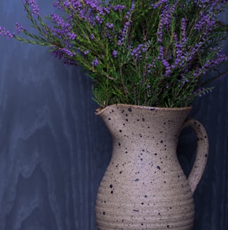 lavender flower in beige pitcher vase