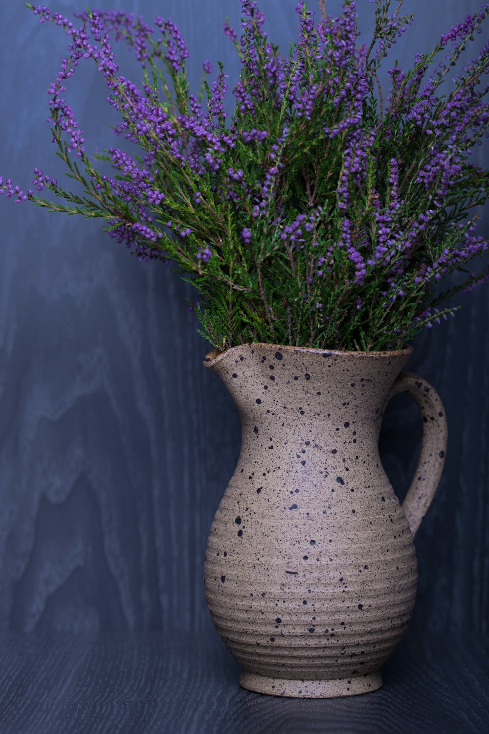 lavender flower in beige pitcher vase