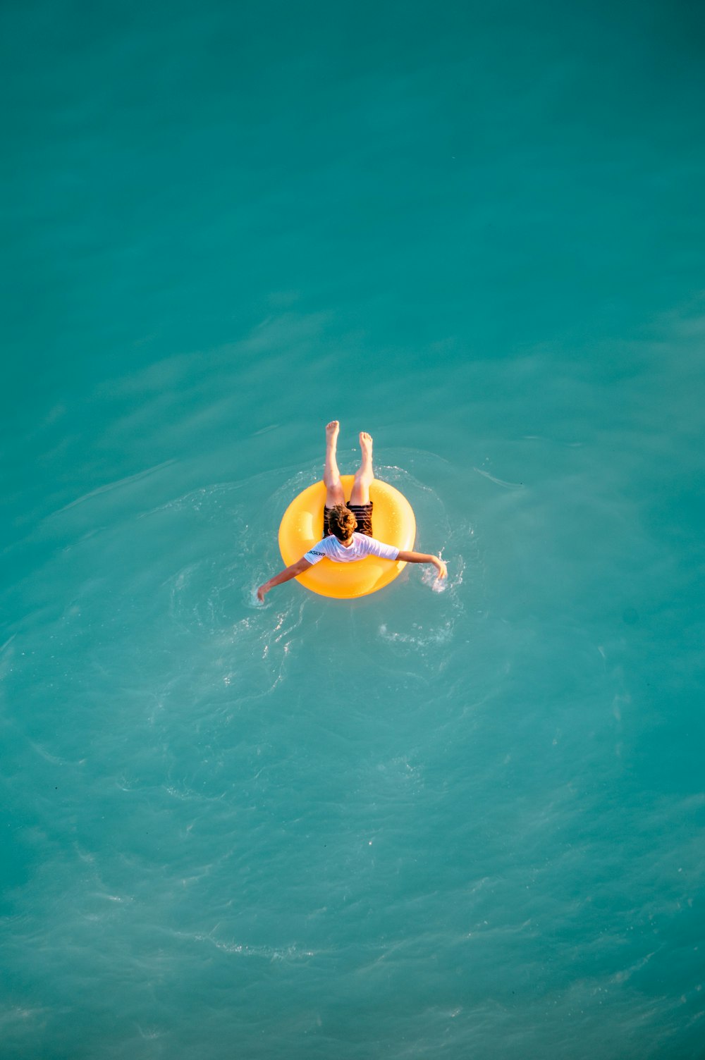 boy sitting on buoy