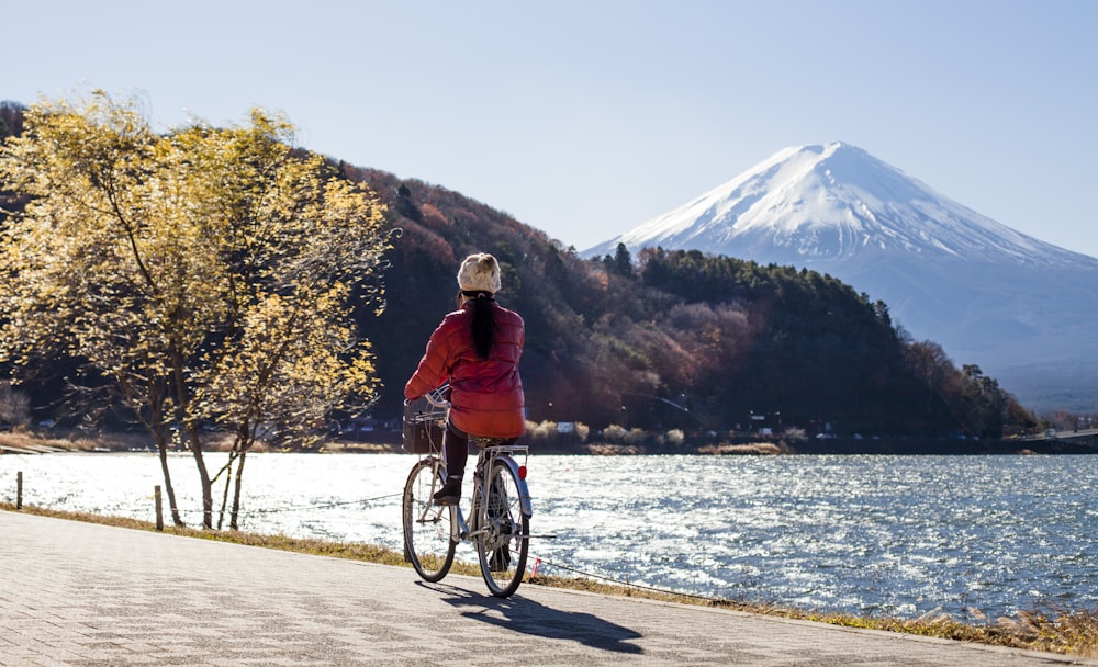 person riding bicycle near body of water