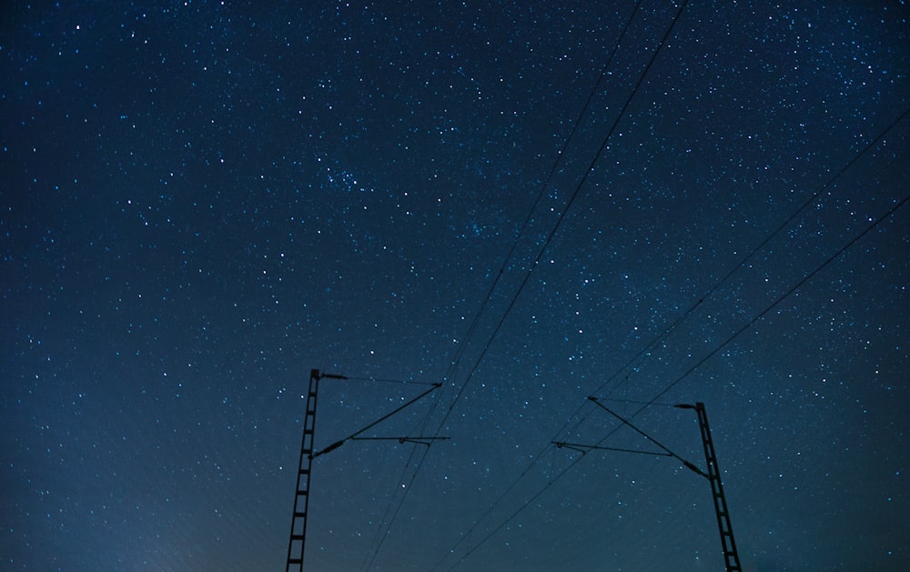 photo of electric post during night time