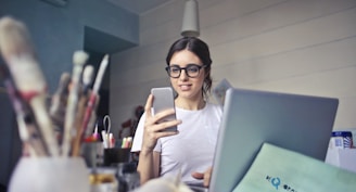 woman in white shirt using smartphone