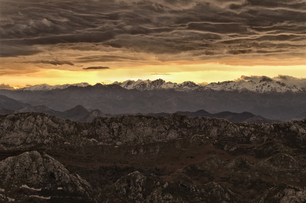 mountain under cloudy sky during sunset