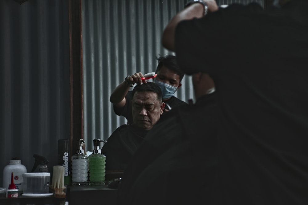 photo of man having a haircut