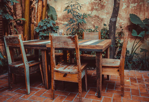 Outdoor patio setup with rustic furniture and greenery.